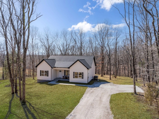 modern farmhouse featuring driveway, covered porch, a front yard, a shingled roof, and central AC unit