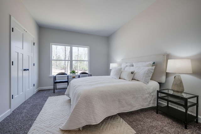 bedroom featuring baseboards and carpet