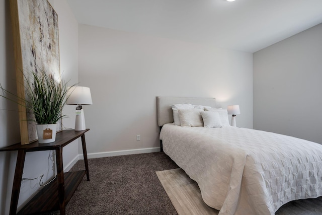 bedroom with baseboards and carpet floors