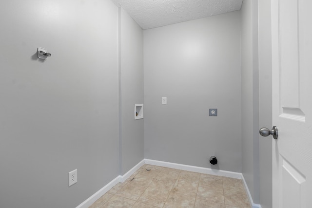 laundry area featuring baseboards, hookup for an electric dryer, laundry area, washer hookup, and a textured ceiling