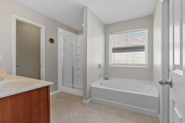 full bath with a garden tub, a shower stall, tile patterned flooring, baseboards, and vanity