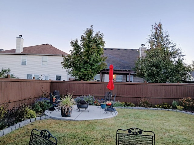 view of yard featuring a patio area, an outdoor fire pit, and a fenced backyard