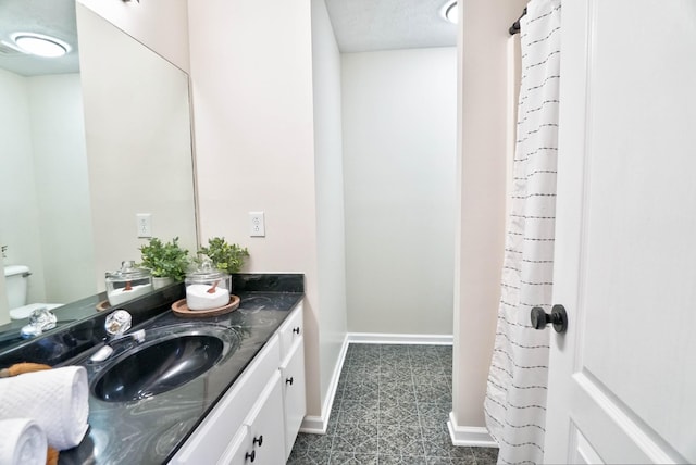 bathroom featuring vanity and baseboards