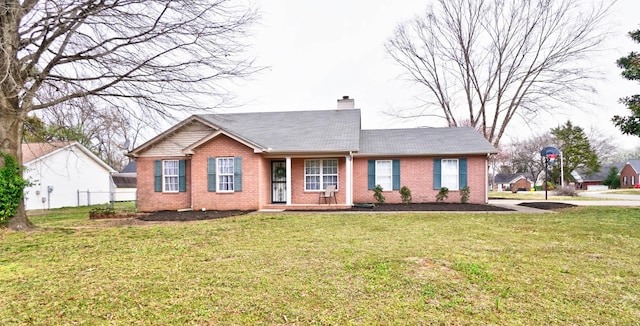 ranch-style home featuring a front lawn, brick siding, and a chimney