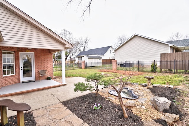 view of yard with central AC unit, a patio area, and fence