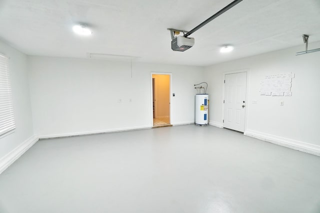 garage featuring water heater, a garage door opener, and baseboards