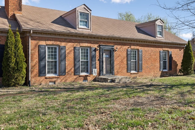 view of front of property with brick siding, crawl space, a shingled roof, and a front yard