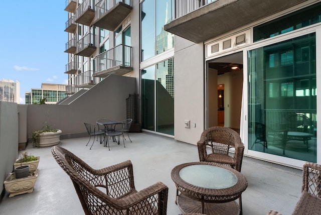 view of patio / terrace featuring stairs and fence