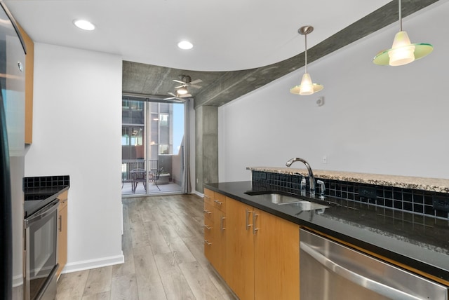 kitchen with light wood-style flooring, electric range oven, a sink, pendant lighting, and dishwasher