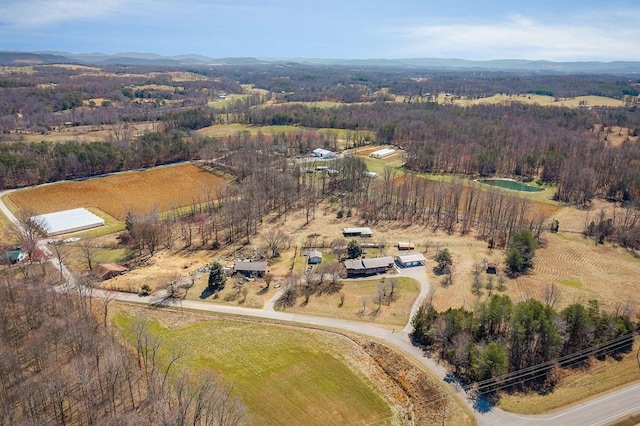 birds eye view of property with a rural view, a mountain view, and a forest view