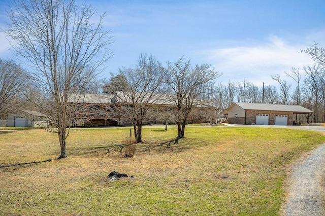 view of front facade with driveway, an attached garage, and a front lawn