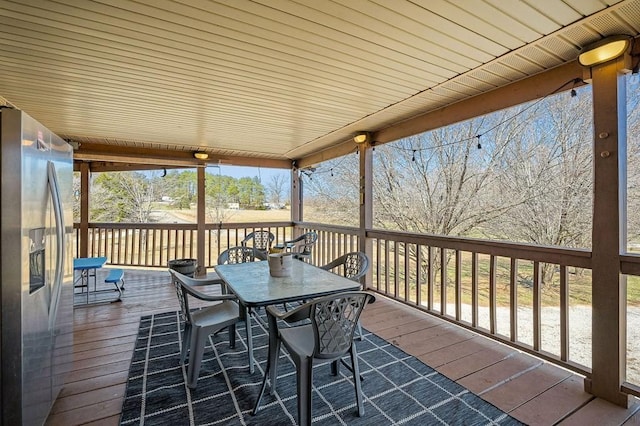 wooden terrace with outdoor dining space