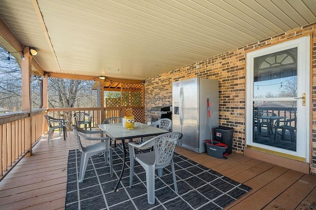 deck featuring outdoor dining area