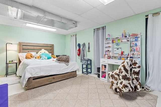 bedroom with wallpapered walls, tile patterned floors, and a paneled ceiling