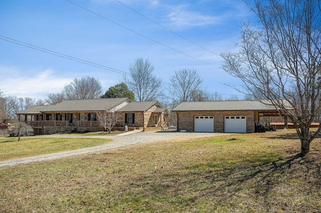 ranch-style house featuring driveway, brick siding, an outbuilding, and a front lawn