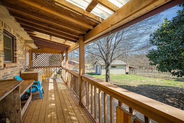 deck featuring an outdoor structure and fence