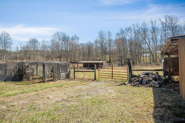 view of yard with an outdoor structure and fence