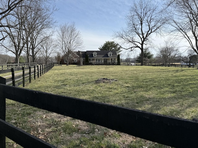 view of yard featuring a rural view and fence