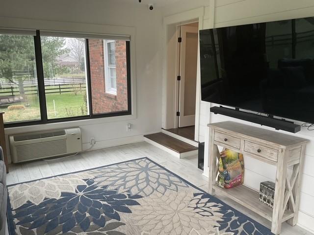 200 Marlin Rd, White House, TN 37188 - living room featuring baseboards, a wall unit AC, and wood finished floors