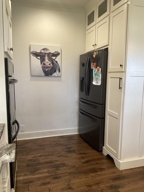 200 Marlin Rd, White House, TN 37188 - kitchen featuring dark wood-style floors, black fridge, white cabinetry, and glass insert cabinets