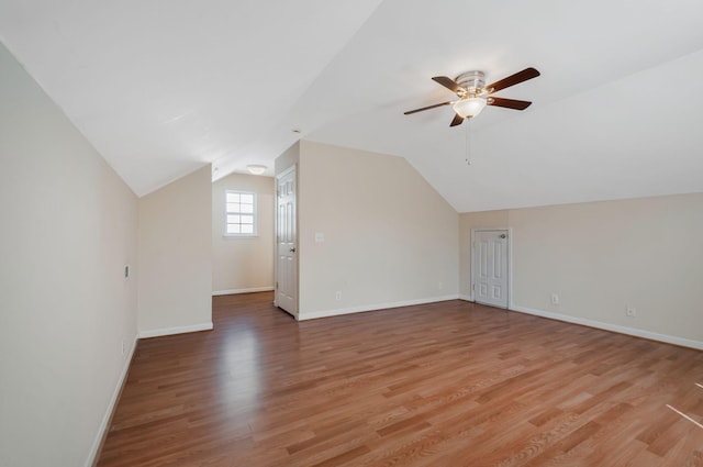 bonus room featuring ceiling fan, baseboards, lofted ceiling, and light wood-style floors