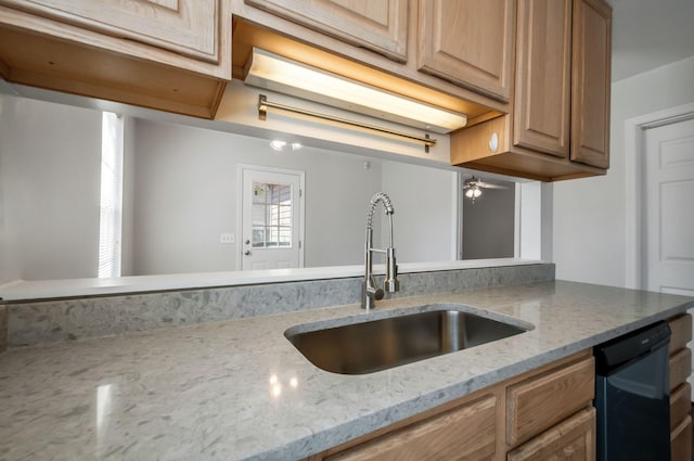 kitchen featuring a sink, light stone countertops, and dishwasher