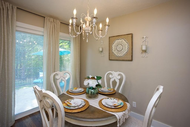 dining area with a chandelier, dark wood-style floors, and baseboards