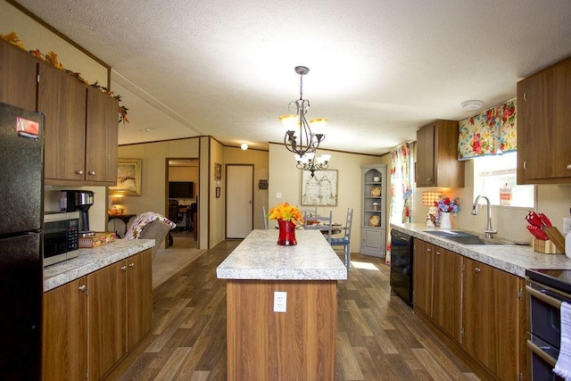 kitchen with a center island, light countertops, dark wood-style floors, black appliances, and a sink