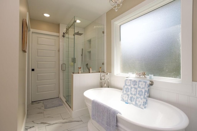 full bathroom with a wainscoted wall, a freestanding tub, recessed lighting, a stall shower, and marble finish floor