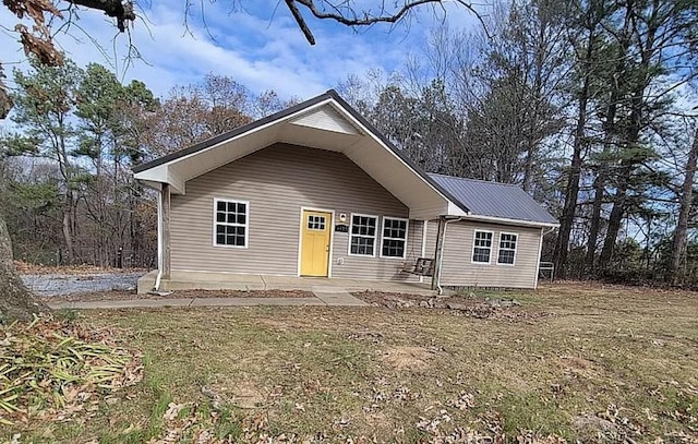 view of front of home with metal roof and a patio