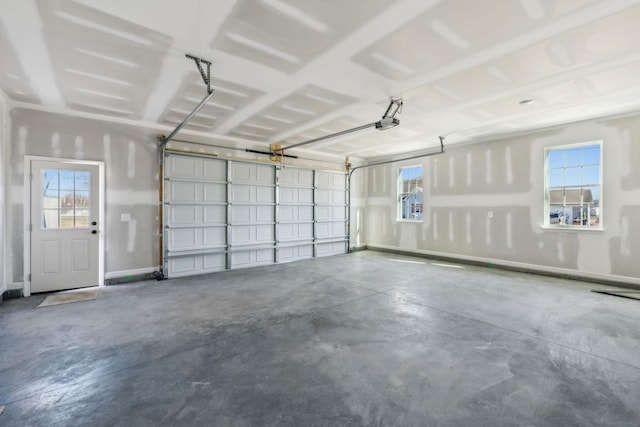 garage with a garage door opener and baseboards