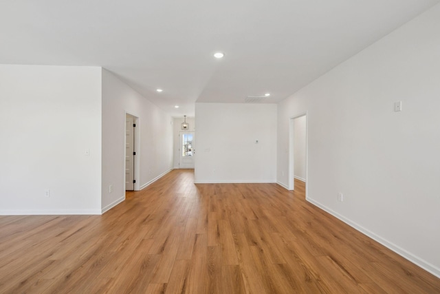 unfurnished room with recessed lighting, light wood-type flooring, and baseboards