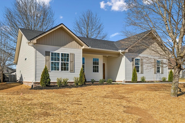 ranch-style home featuring roof with shingles and central AC unit