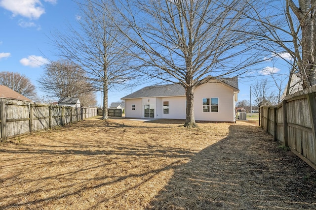 rear view of property featuring a patio area and a fenced backyard