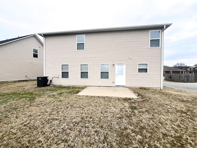 back of property featuring a yard, central air condition unit, and a patio