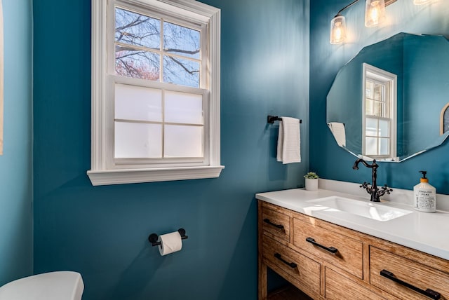 bathroom featuring toilet and vanity