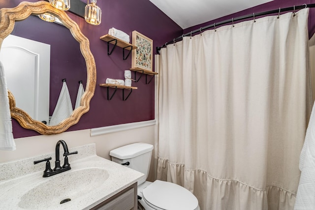 full bathroom with toilet and vanity