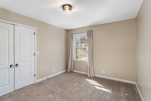 unfurnished bedroom with baseboards and carpet