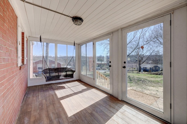 unfurnished sunroom with a healthy amount of sunlight and wood ceiling