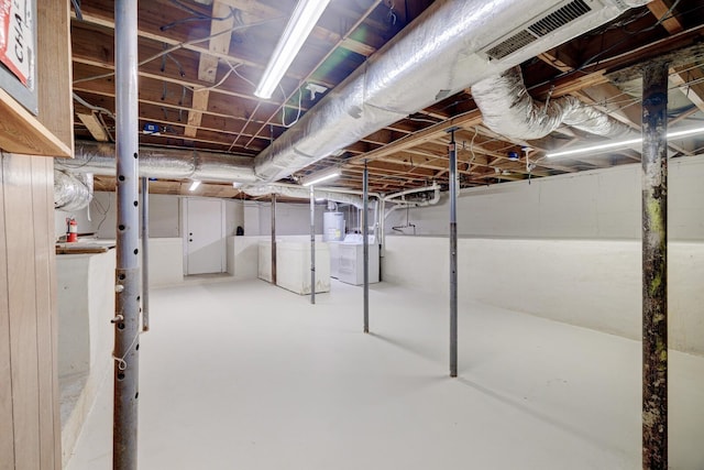 unfinished basement with visible vents and washer / dryer