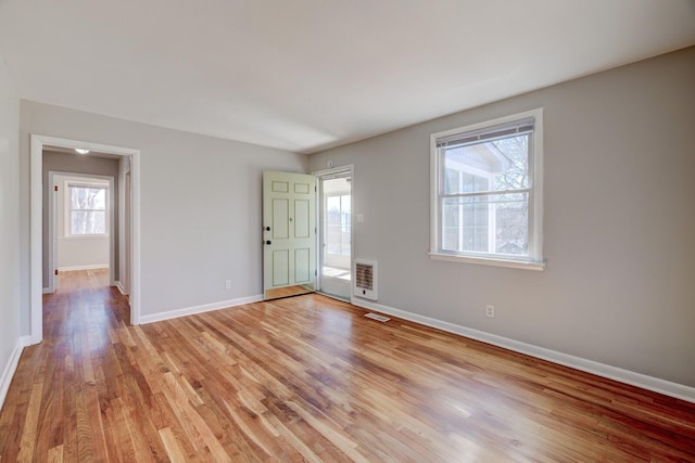 interior space featuring light wood finished floors, visible vents, and baseboards