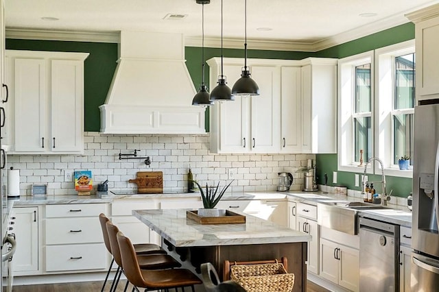 kitchen with a sink, premium range hood, a wealth of natural light, and stainless steel appliances