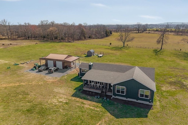 birds eye view of property with a rural view