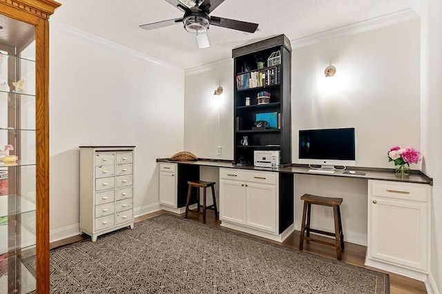 office featuring wood finished floors, built in study area, and ornamental molding