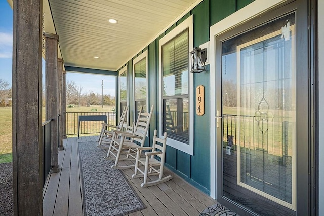 wooden terrace featuring covered porch