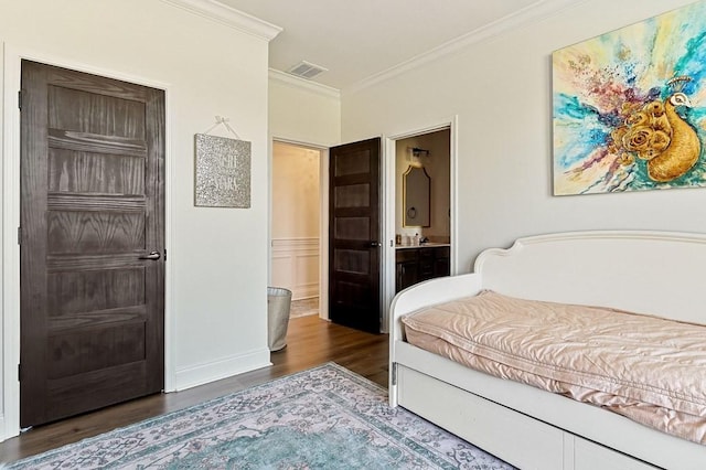 bedroom with visible vents, connected bathroom, crown molding, baseboards, and dark wood-style flooring