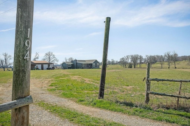 view of yard featuring a rural view and driveway