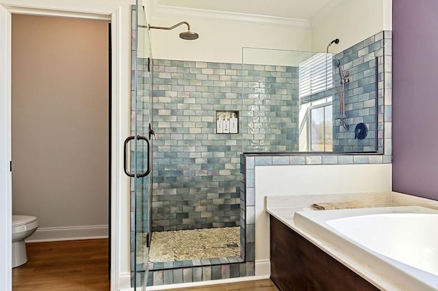 bathroom with a shower stall, wood finished floors, and ornamental molding