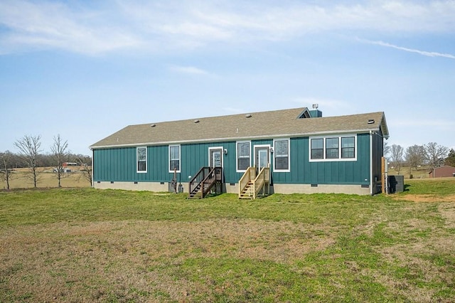 back of house with crawl space, central air condition unit, a lawn, and entry steps