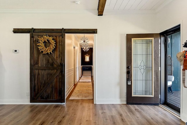 entryway featuring beamed ceiling, baseboards, and wood finished floors